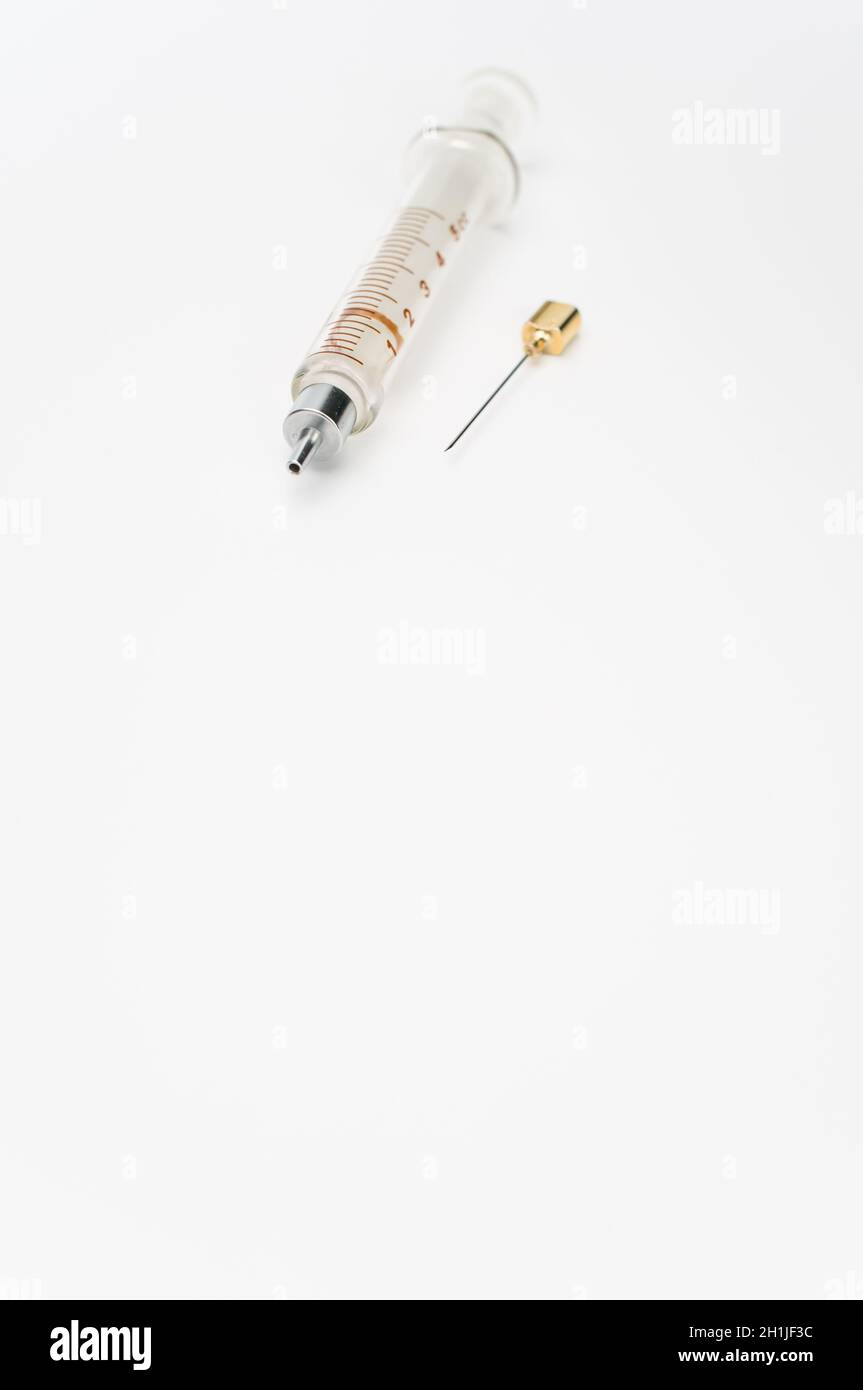 Touching Glass Injection isolated sterilized glass injection syringe on a white surface Stock ...