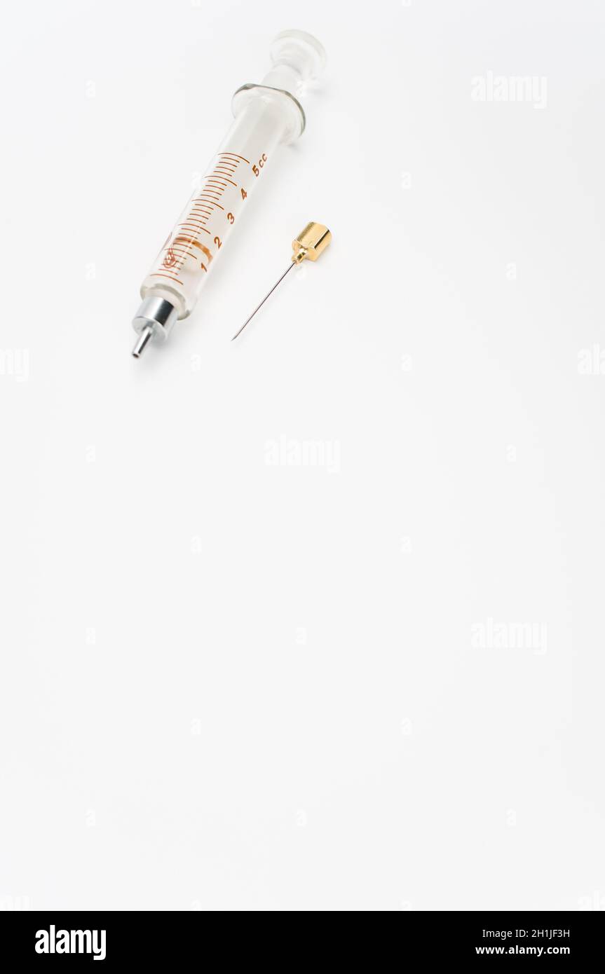 Touching Glass Injection isolated sterilized glass injection syringe on a white surface Stock ...
