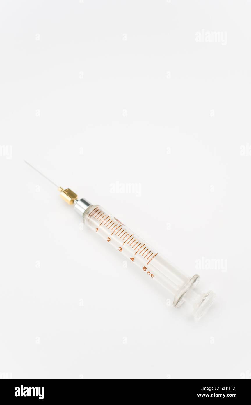 Touching Glass Injection isolated sterilized glass injection syringe on a white surface Stock ...