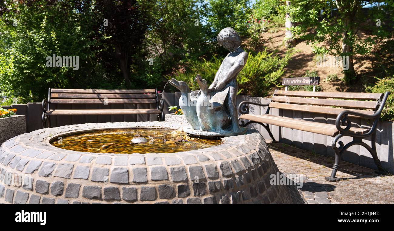 SCHALKENMEHREN, GERMANY - JUNE 23, 2020: Close up image of the fountain of the Eifelverein with benchs, on June 23, 2020 in Schalkenmehren, Germany Stock Photo