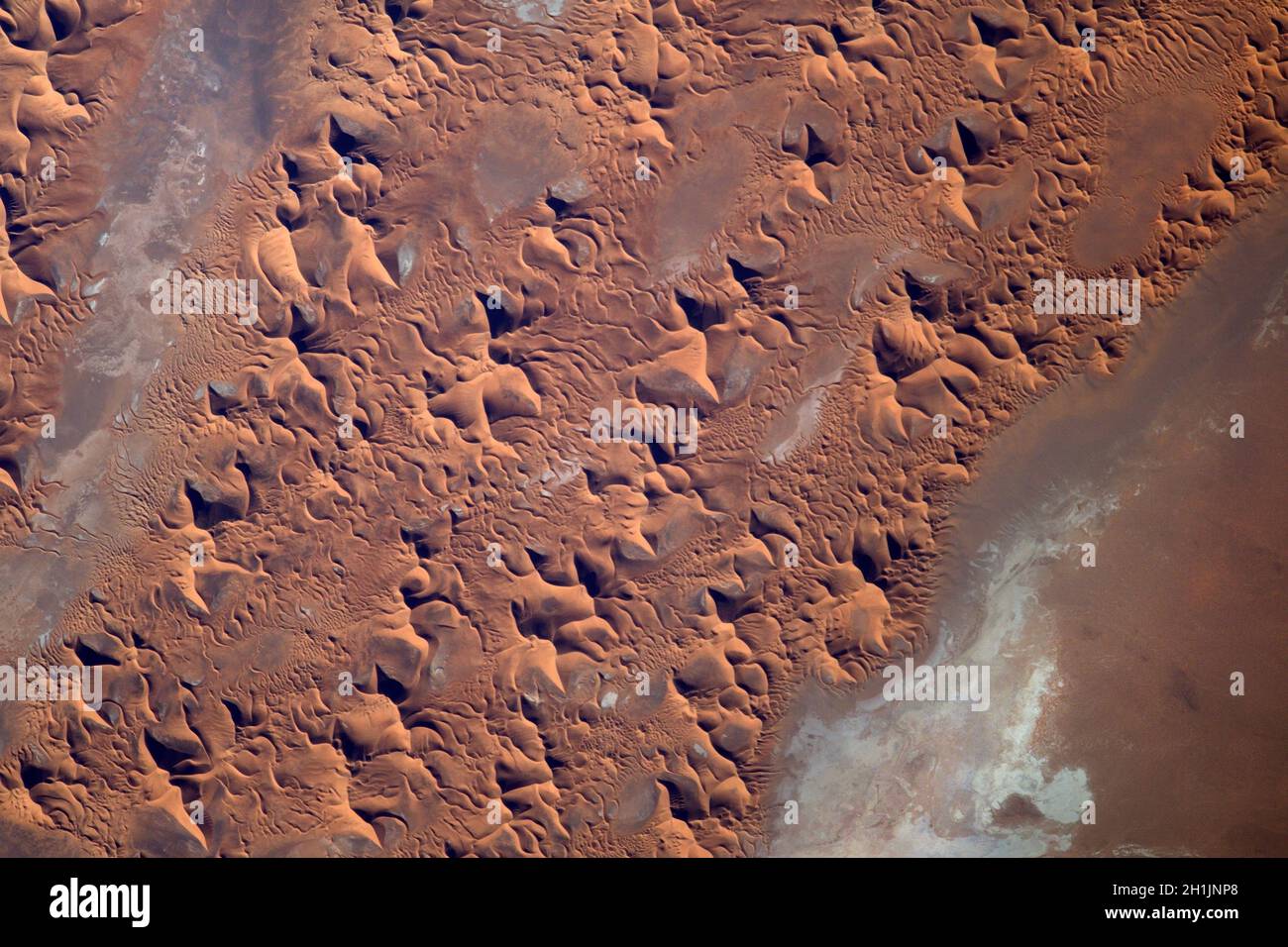 A view of Earth from the International Space Station: Saharan sand Dunes, the Sahara desert. An optimised and digitally enhanced version of a NASA/ ESA image. Mandatory Credit: NASA/ESA/T. Pesquet. NB: Usage restrictions: Not to be presented as an endorsement. Stock Photo