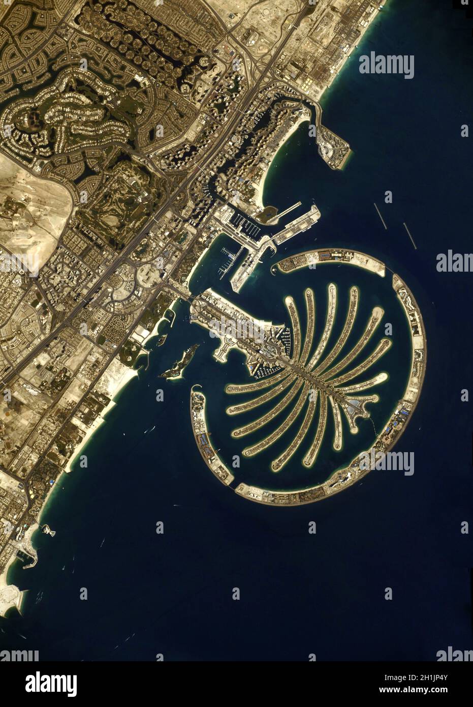 A view of Earth from the International Space Station:  Dubai and the man-made Palm Jumeirah islands. The construction of the Palm Islands involves dredging sand from the bottom of the Persian Gulf United Arab Emirates Dubai. tourist and residential development.  An optimised and digitally enhanced version of a NASA/ ESA image. Mandatory Credit: NASA/ESA/T. Pesquet. NB: Usage restrictions: Not to be presented as an endorsement. Stock Photo