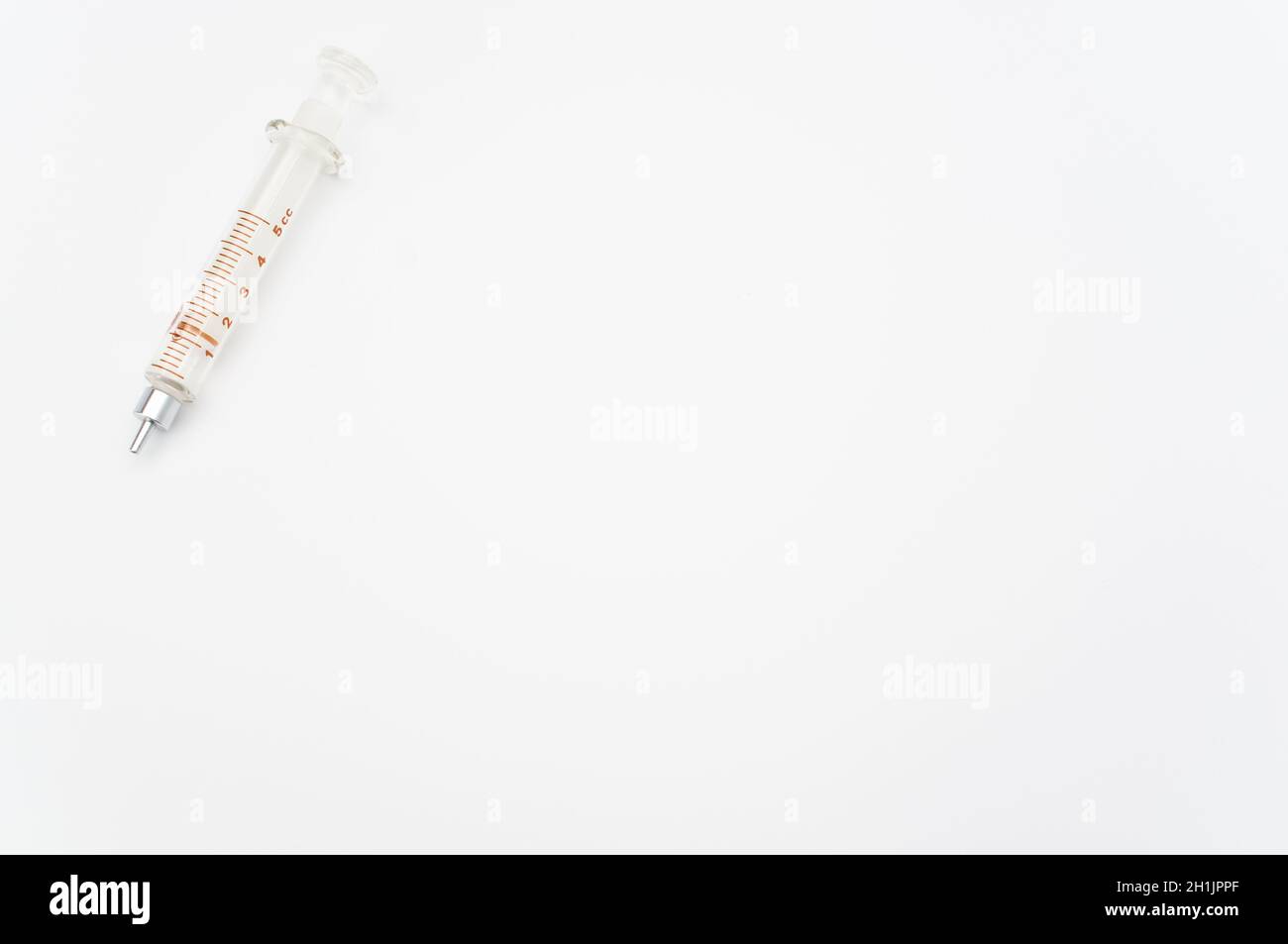 isolated sterilized glass injection syringe on a white paper background