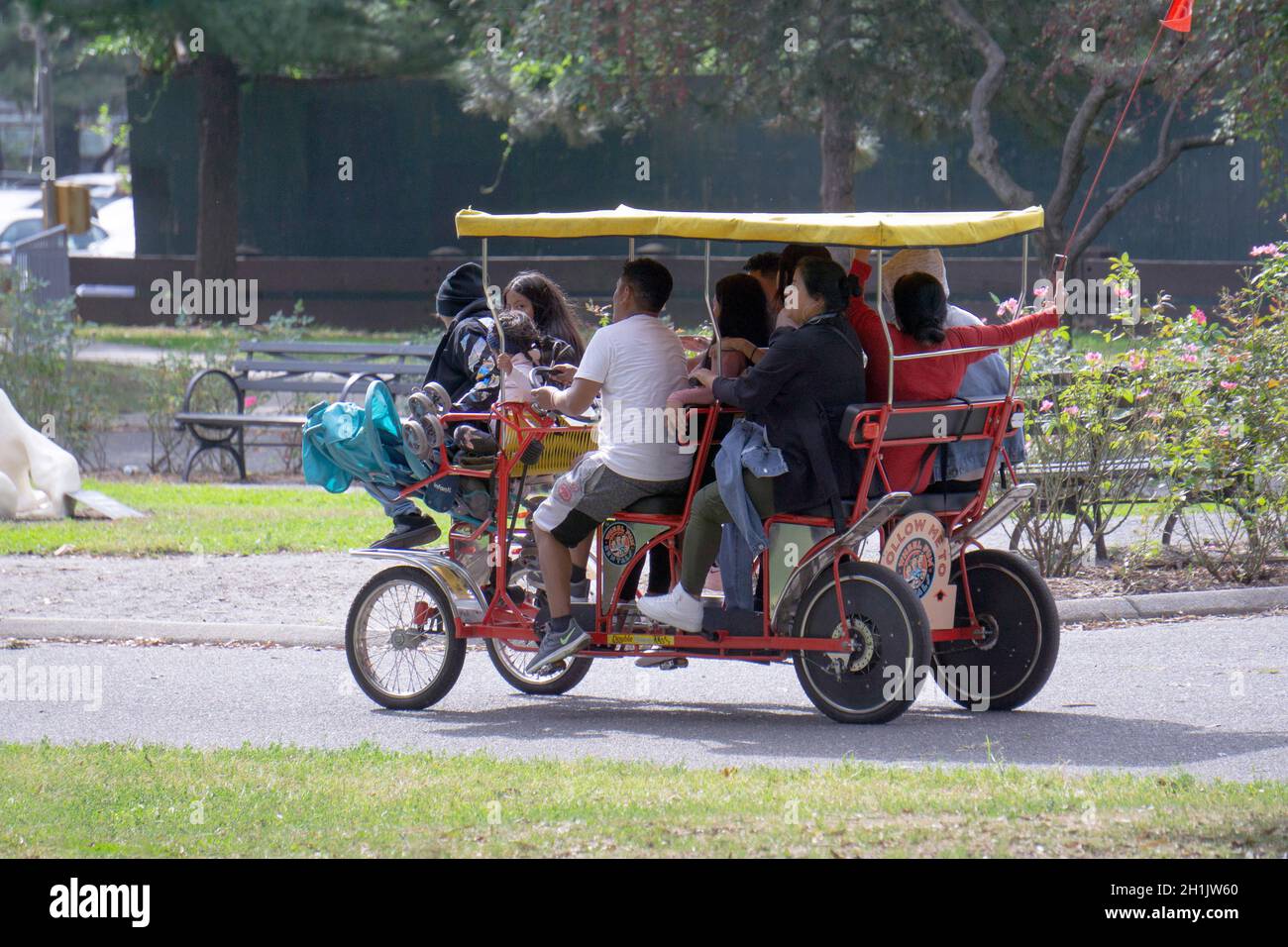 BICYCLE BUILT FOR 10. Ten people cram into a Wheel Fun rental cycle in Flushing Meadows Corona