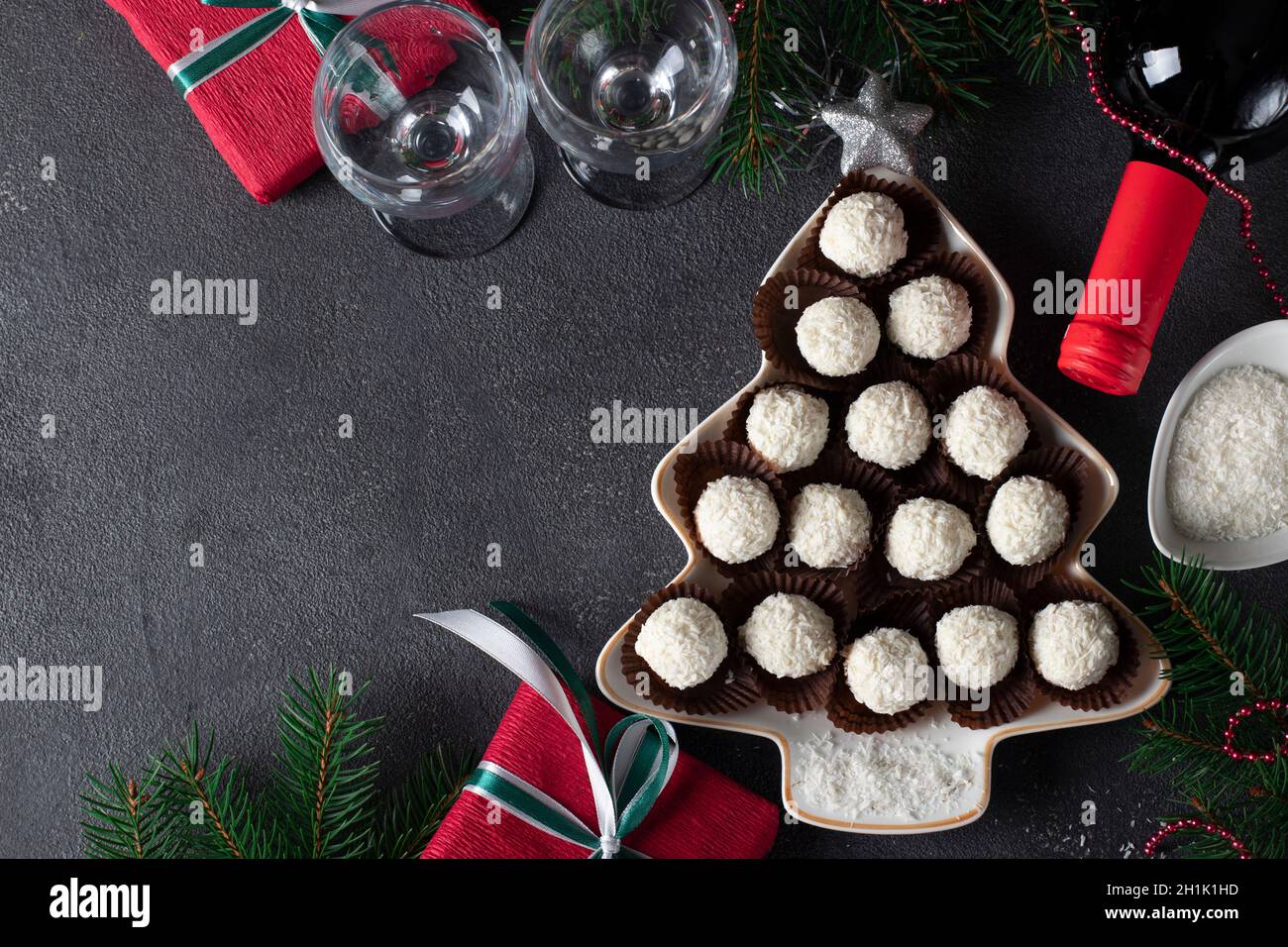 Sweet coconut rafaello candies served in plate as Christmas tree. Top view Stock Photo