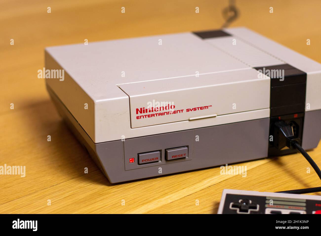 A Nintendo Entertainment System With a Controller Plugged In. The