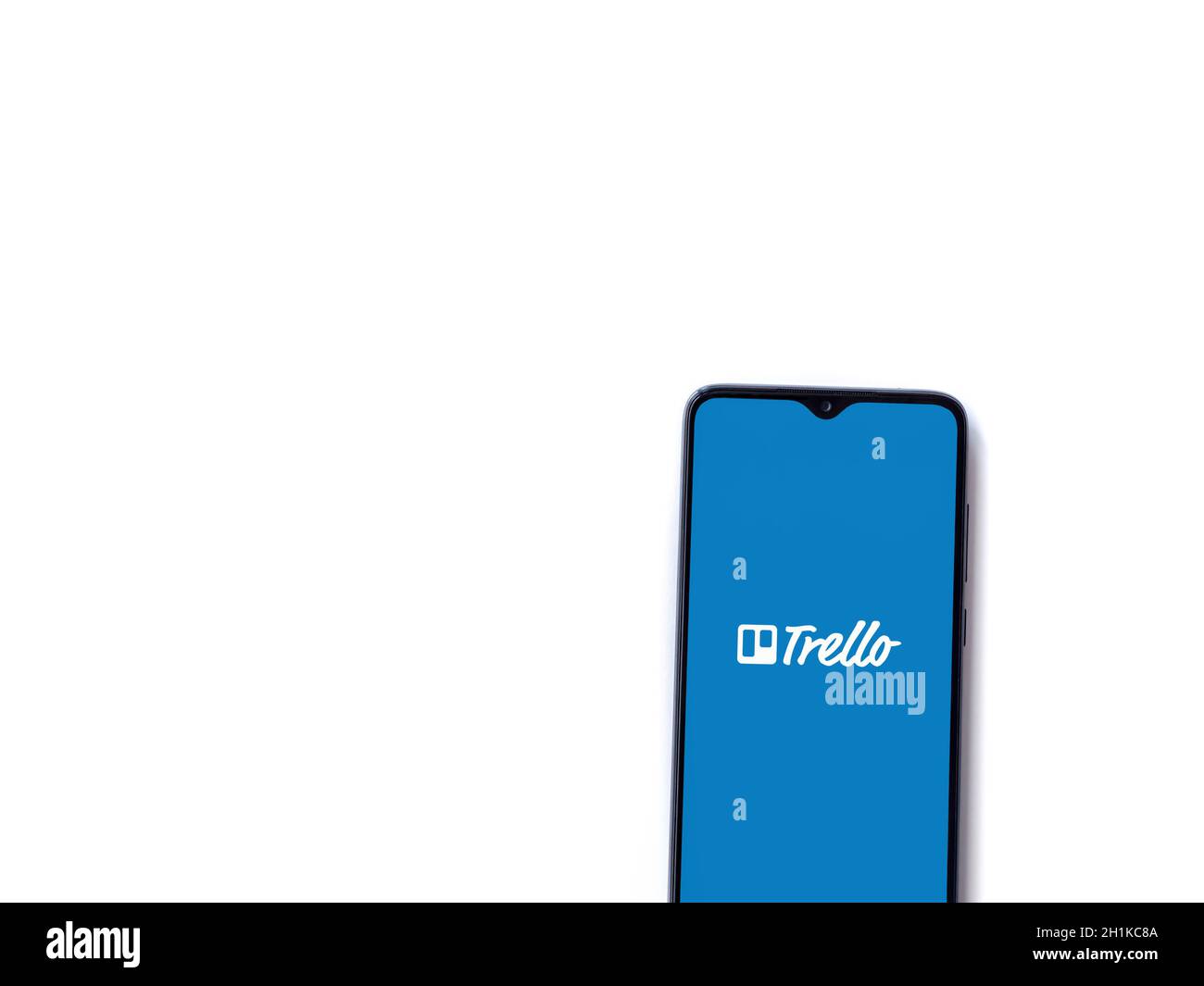 Lod, Israel - July 8, 2020: Trello app launch screen with logo on the display of a black mobile smartphone isolated on white background. Top view flat Stock Photo