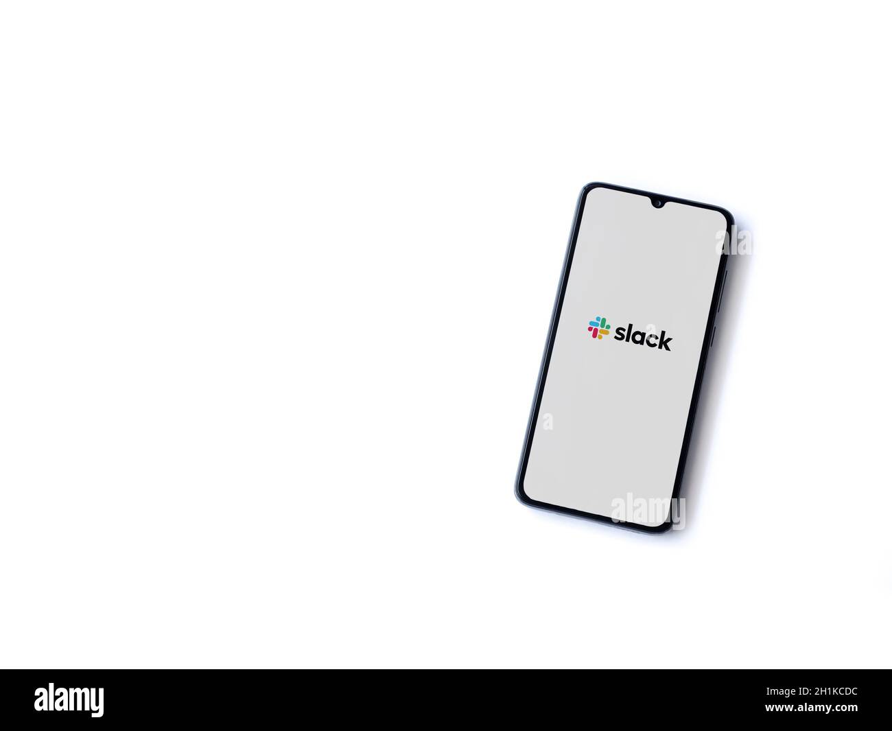 Lod, Israel - July 8, 2020: Slack app launch screen with logo on the display of a black mobile smartphone isolated on white background. Top view flat Stock Photo