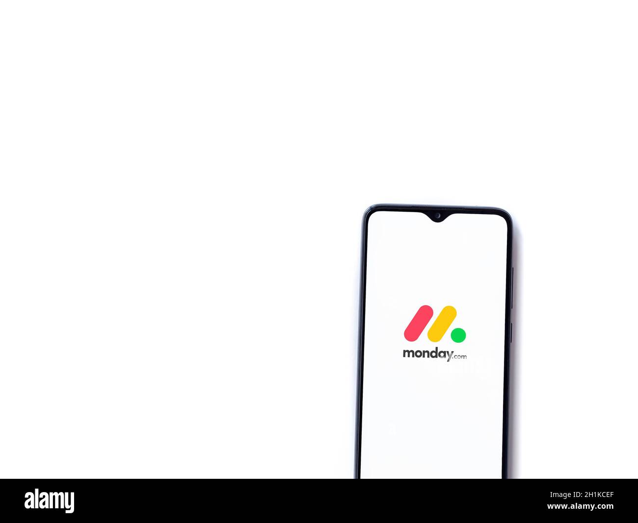 Lod, Israel - July 8, 2020: Monday app launch screen with logo on the display of a black mobile smartphone isolated on white background. Top view flat Stock Photo