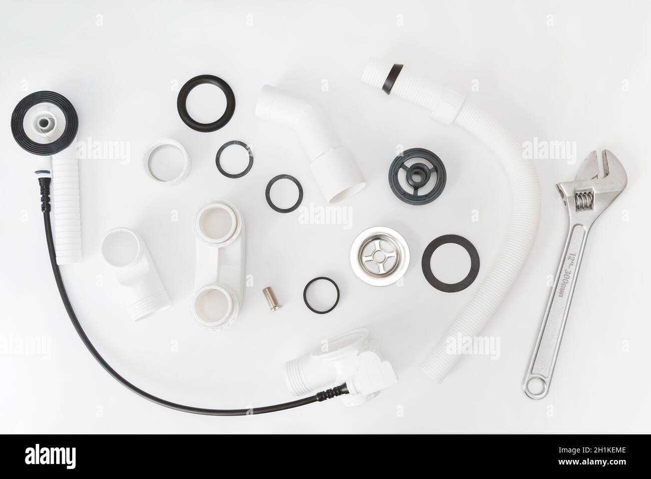 Details plastic siphon kit for bathtub on a white background. Plumbing knolling on white background. Stock Photo