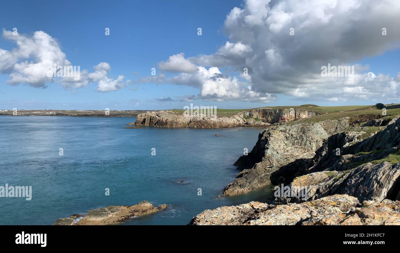 Landscape of cliffs surrounded by the sea under the sunlight and a blue ...
