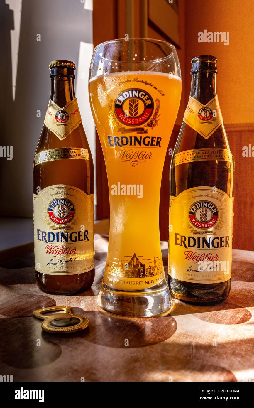 Erdinger beer is poured in a branded beer glass and two bottles of beer on the side. Erdinger beer on the table. 04.07.2015 Kiev Ukraine Stock Photo