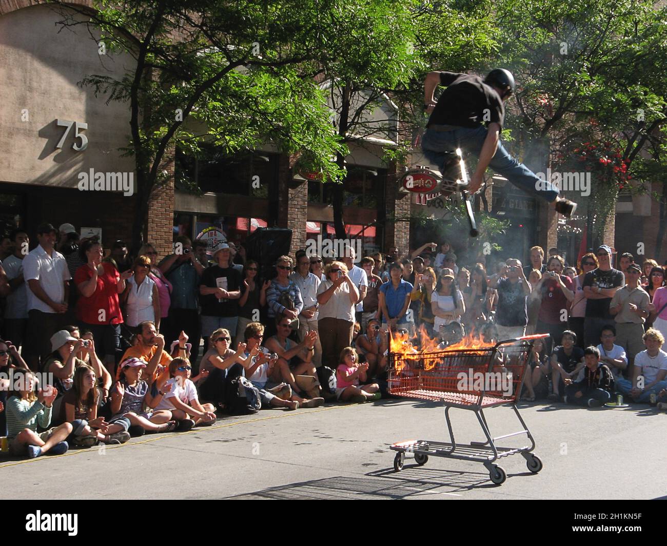 Toronto, Ontario / Canada - Aug. 21, 2008: Performing Acrobat of jumping over the fire on the Street Festival Stock Photo