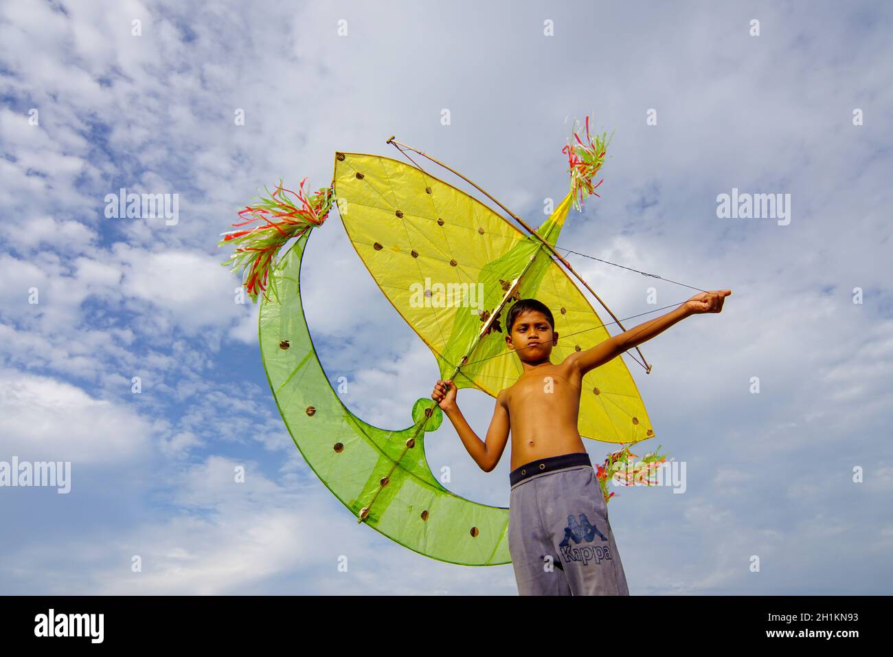 Kota Bahru, Kelantan/Malaysia - Jul 15 2017: Asian kid play traditional moon kite (wau bulan). Stock Photo