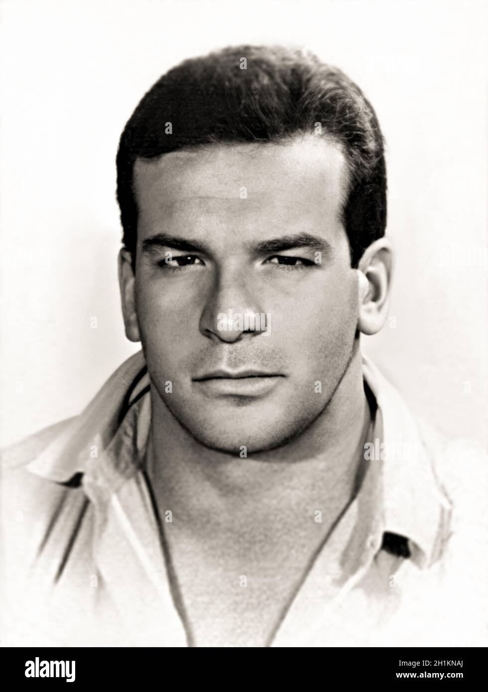 1956 , Rome , ITALY : The italian celebrated actor , professional swimmer and water polo player CARLO PEDERSOLI aka BUD SPENCER ( 1929 - 2016 ), young swimmer aged 27 . Photo taken for the ID pass at 1956 Summer OLYMPICS GAMES in Melburne ( Australia ), in which Pedersoli in the 100 m freestyle still reached the semifinal . After the Olympic Games, along with other promising athletes, he was invited to Yale University , where he spent a few months in the United States , setting his personal best in the 100m freestyle . Unknown photographer .-  HISTORY - FOTO STORICHE - ATTORE - MOVIE - CINEMA Stock Photo