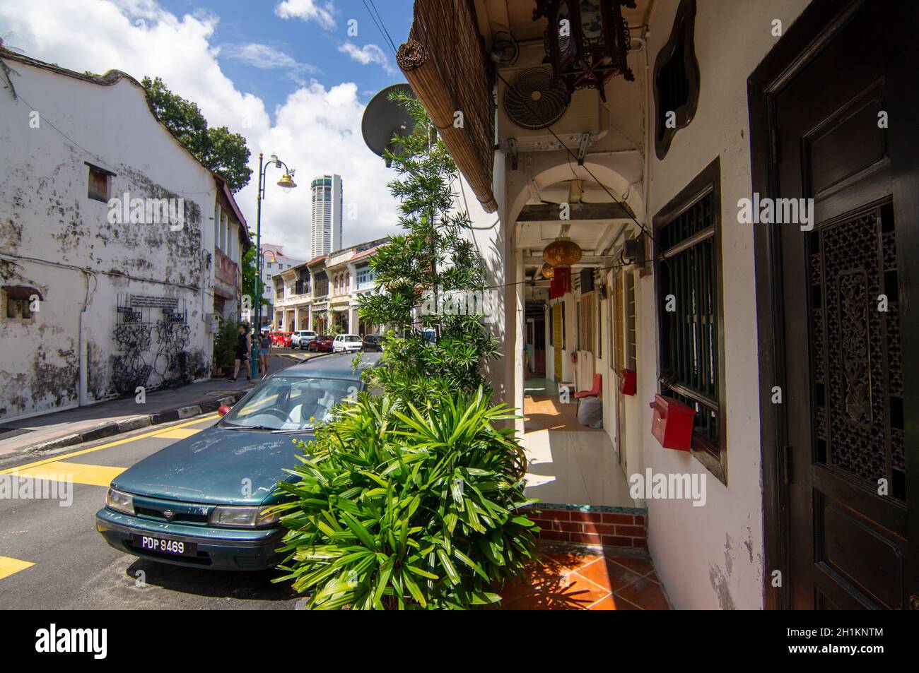 George Town, Penang/Malaysia - Nov 11 2019: An old heritage house at Lebuh Armenian. Background is KOMTAR building. Stock Photo