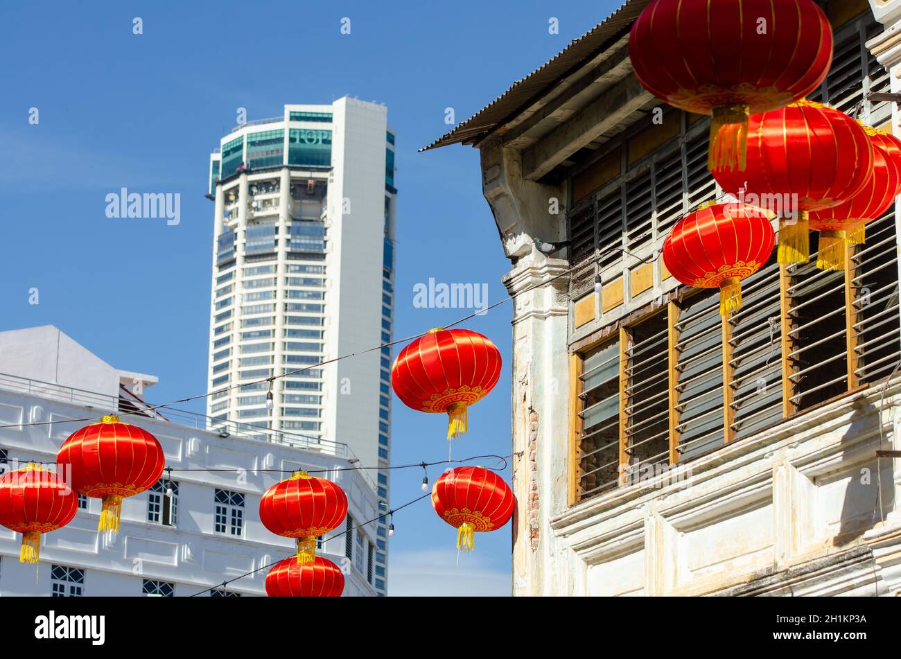 Georgetown, Penang/Malaysia - Jan 03 2020: Red lantern decorated near old heritage house. Background is KOMTAR building. Stock Photo