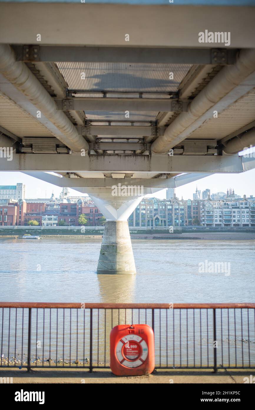 London, UK - September 1, 2020: Orange Emergency Floatation Device Along the Thames Path in the UK Stock Photo
