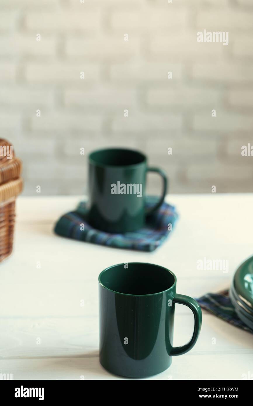 Green plastic kitchenware on a table close up Stock Photo