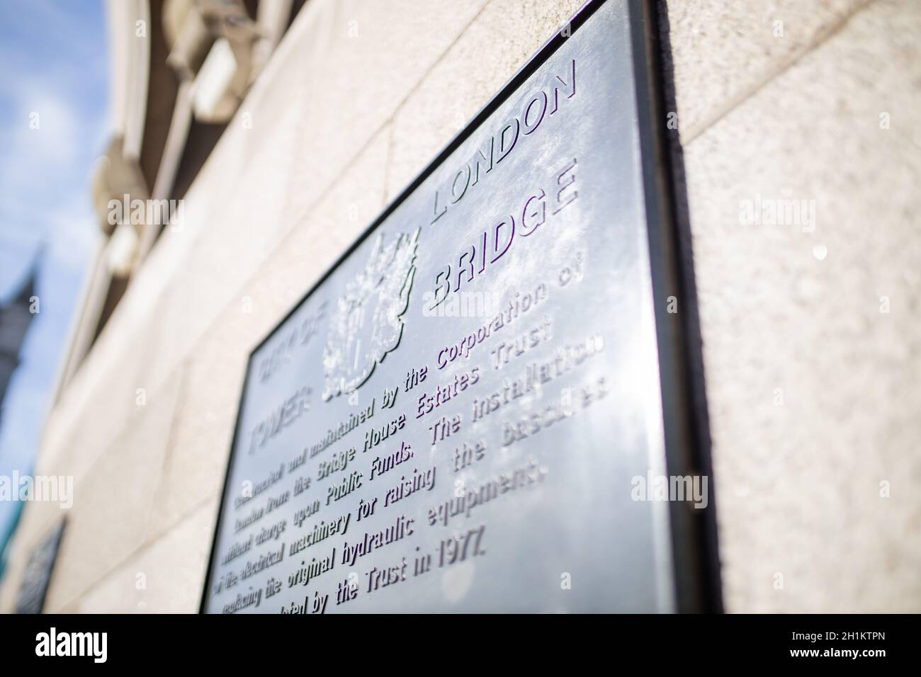 London, UK - September 30, 2020: Landscape view of the Tower Bridge commemorative plaque on a concrete wall, with the London coat of arms and the brid Stock Photo