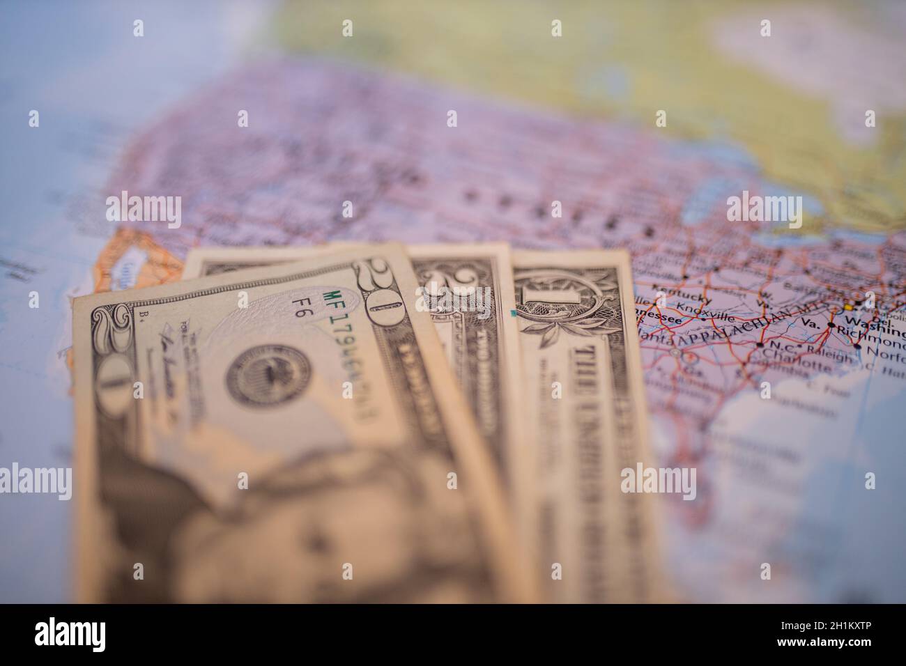 Close up picture of blurry banknotes of one, two, and twenty dollars ...