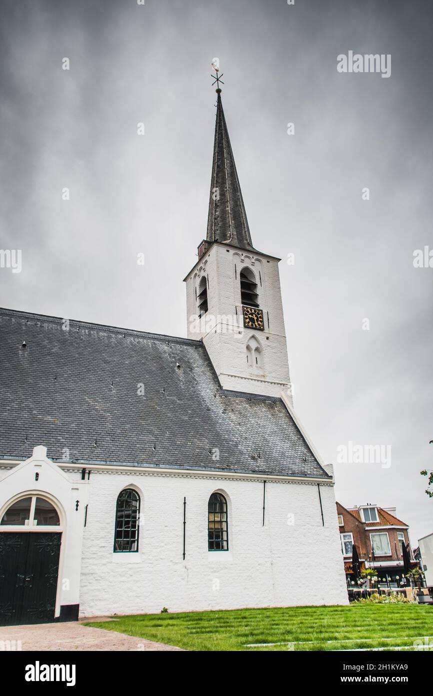 White church in Noordwijkerhout in the Netherlands with cloudy sky Stock Photo