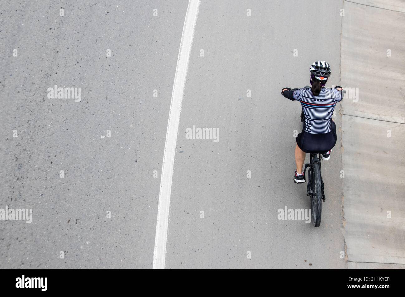 Overhead shot of anamateur woman cyclist on the road between Bogota and La Calera on the mountains in Colombia Stock Photo