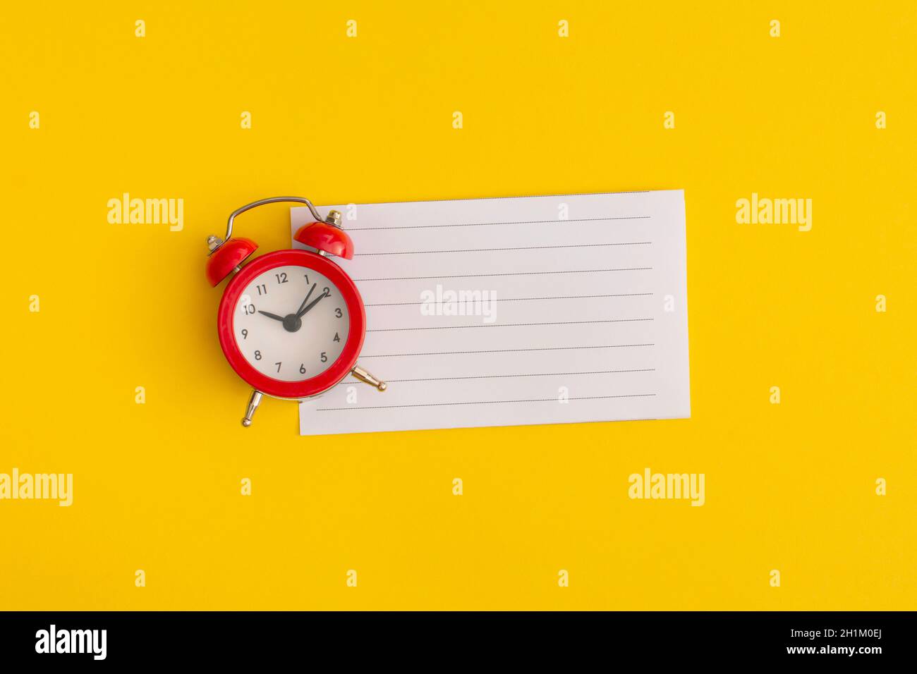 Antique alarm clock on a yellow background Stock Photo - Alamy