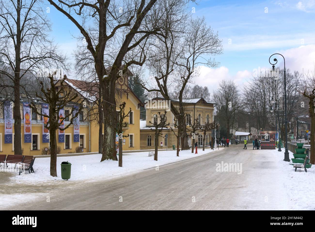 Krynica Zdroj, Poland - January 26, 2020: Tourists walk Dietls boulevards, famous promenade of Krynica on a winter day Stock Photo