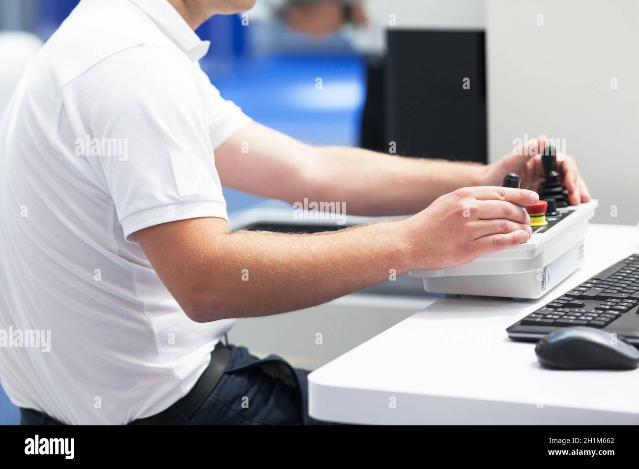 Engineer is using joystick to operate electronic device Stock Photo