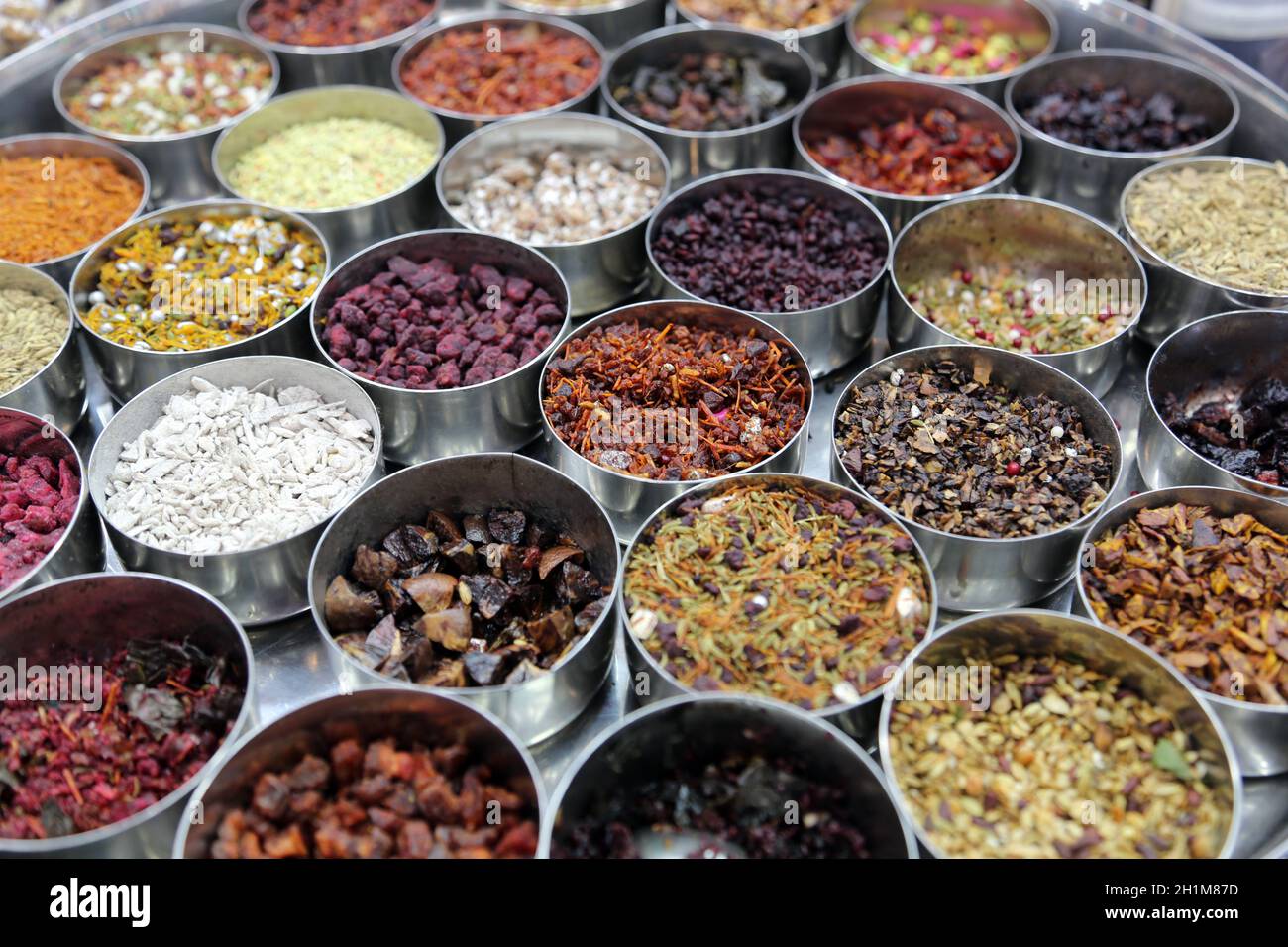 Different spices and herbs in metal bowls on a street market in Kolkata