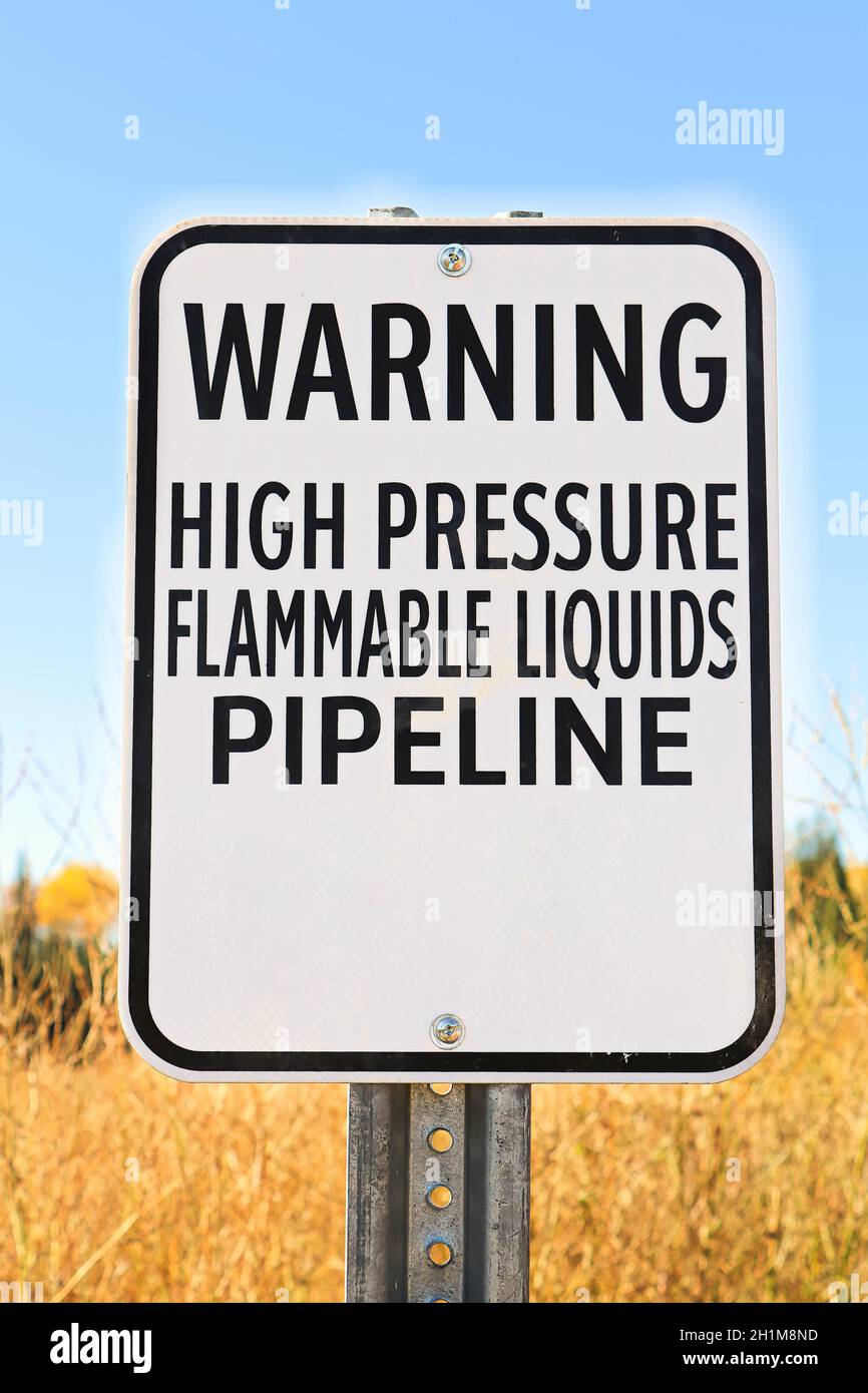 A Warning High Pressure Pipeline Flammable Liquids sign. Stock Photo