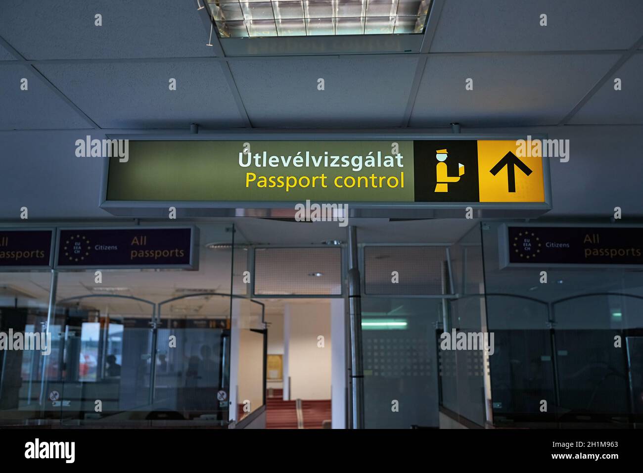 Signs for the border passport control at an international airport terminal, also written in Hungarian language, which translates exactly to passport c Stock Photo