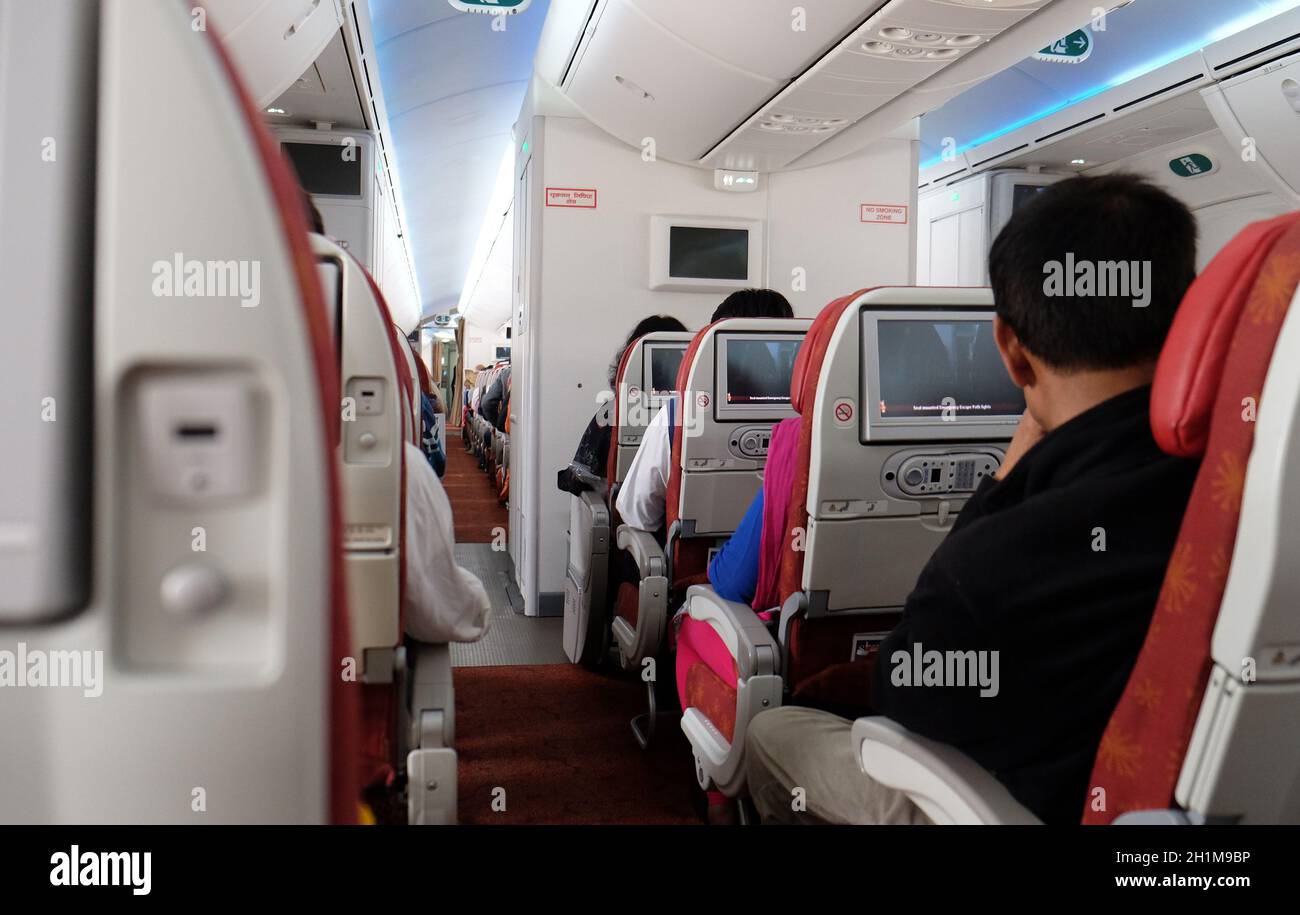 Airplane interior. Passengers waiting for taking off, Kolkata, India Stock Photo