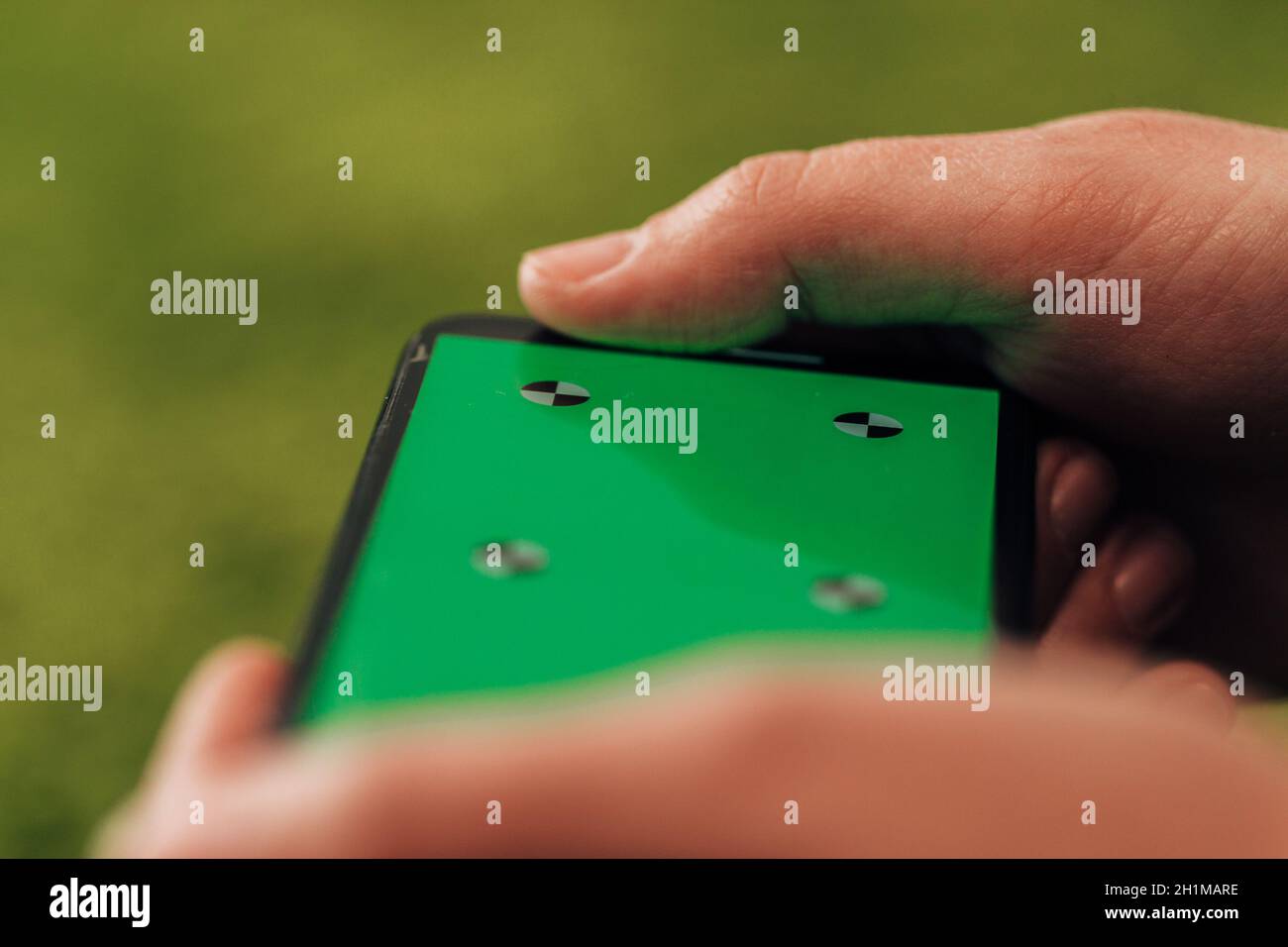 Girl Holds An New Smart Phone In Her Hand. Chroma Key Green. Stock Photo