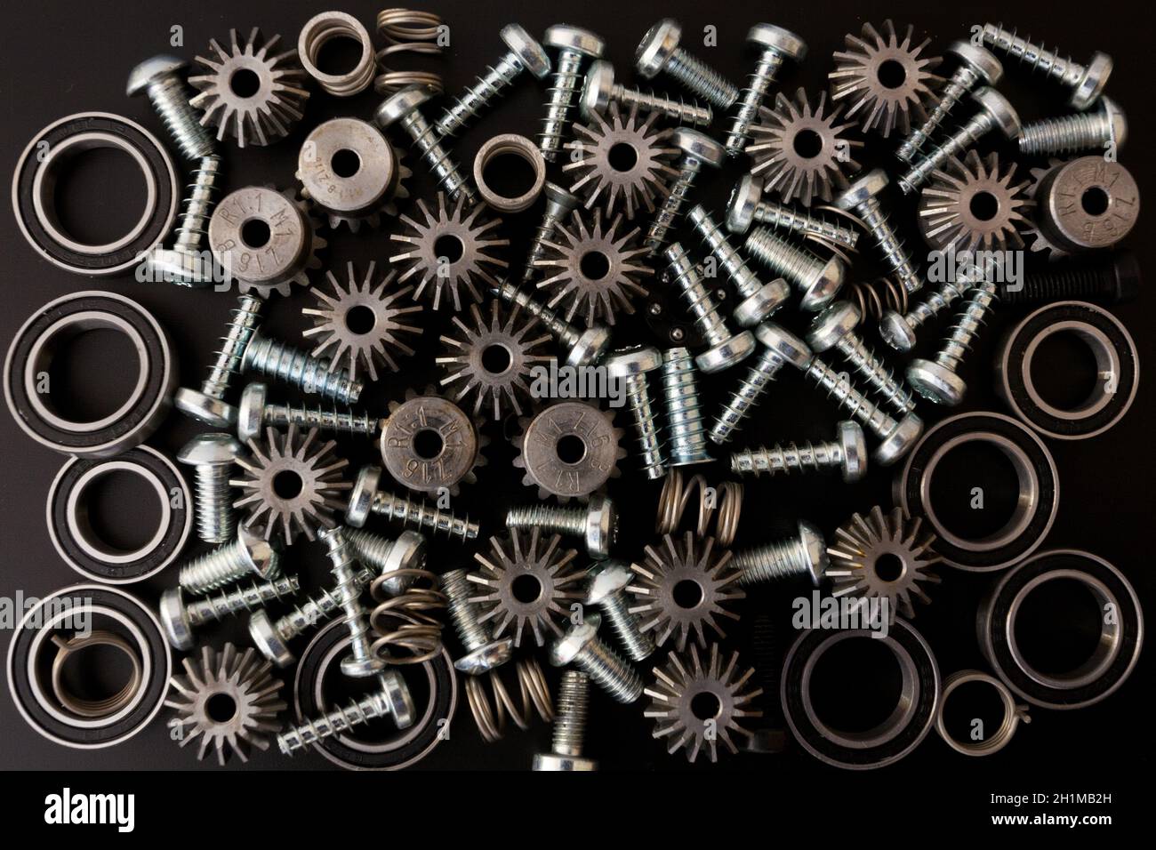 Background with mechanical components, gears, springs, screws, industrial objects Stock Photo