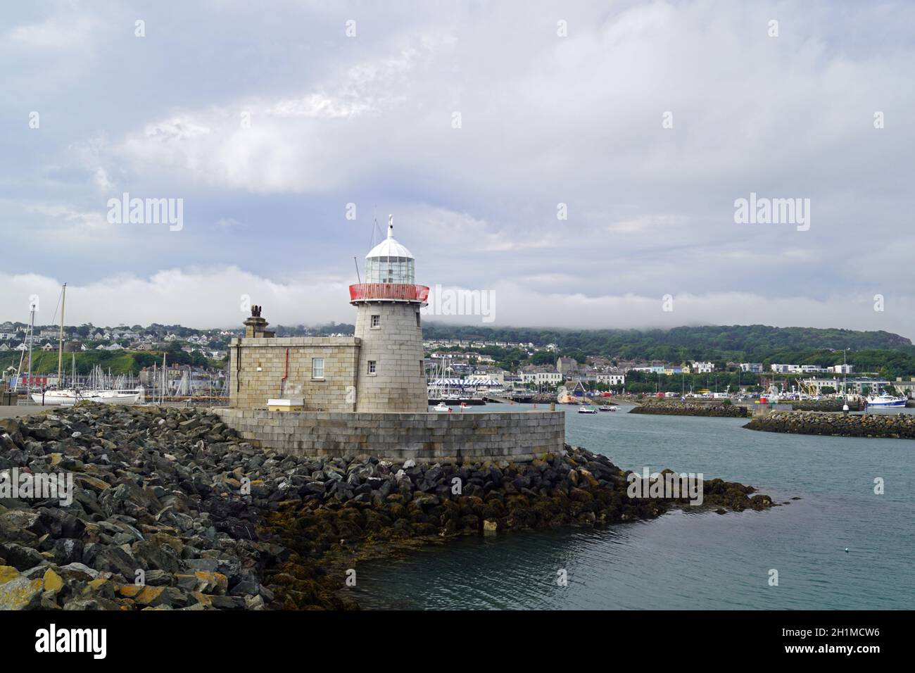 The lighthouse guards the entrance to the port of Howth Stock Photo - Alamy