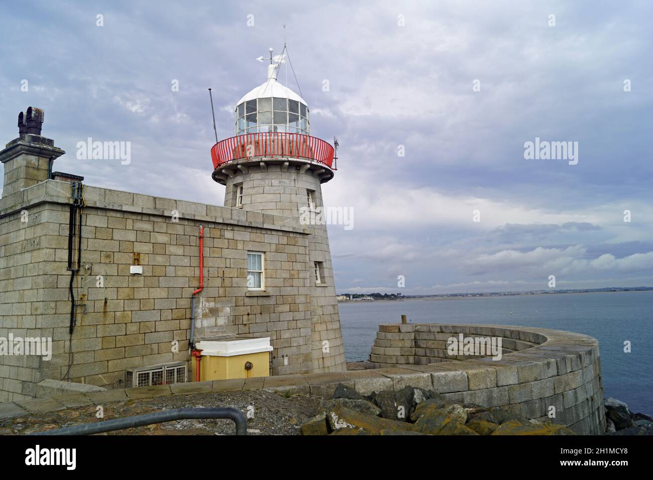 The lighthouse guards the entrance to the port of Howth Stock Photo Alamy