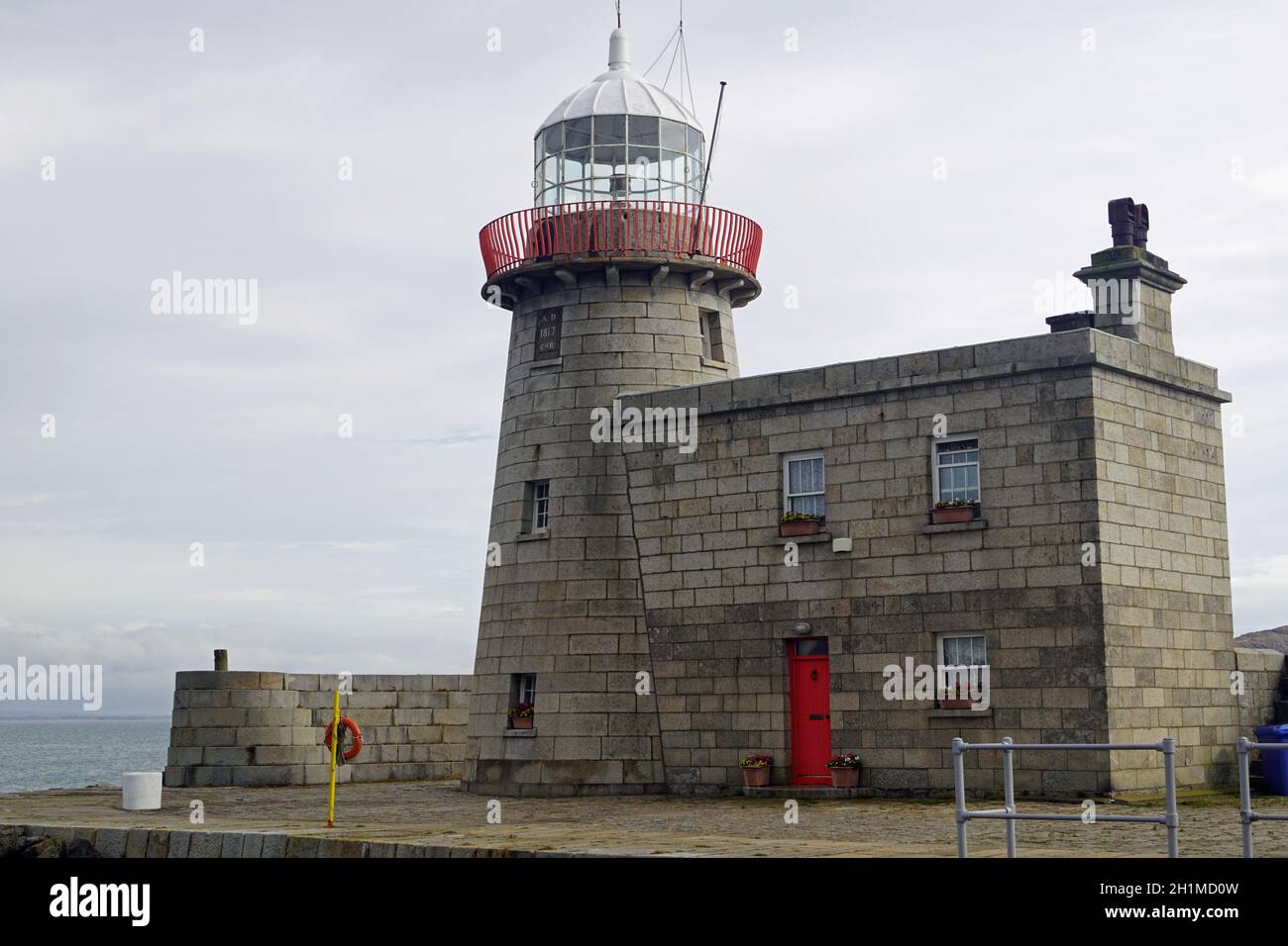 The lighthouse guards the entrance to the port of Howth Stock Photo Alamy