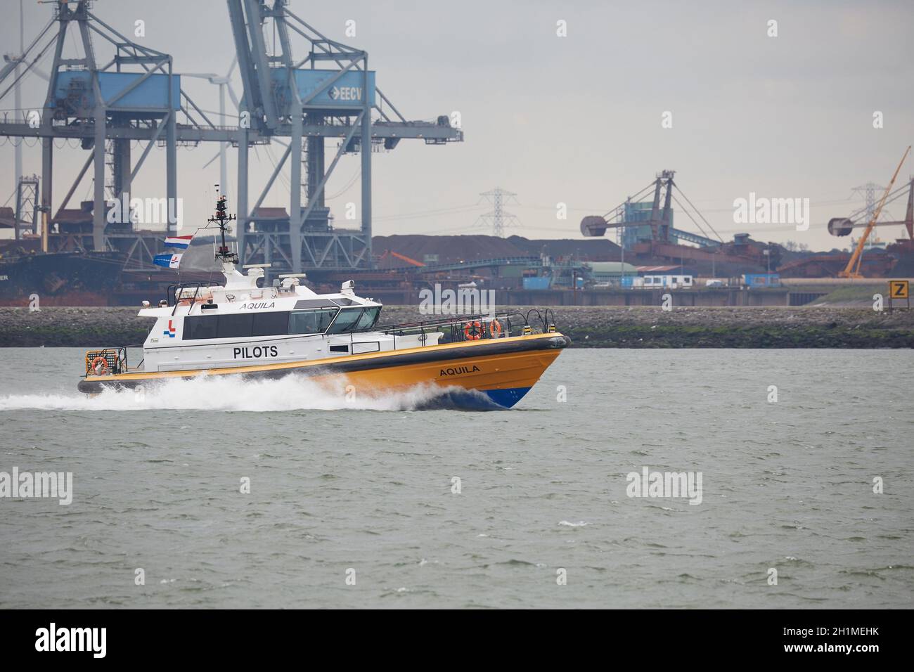 PORT OF ROTTERDAM, THE NETHERLANDS - CIRCA 2017: Pilot boat on the way to help a ship come into port. Stock Photo
