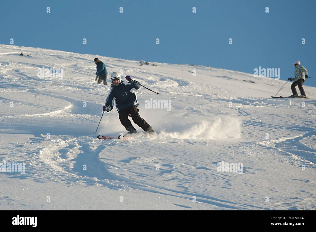 LES ORRES, FRANCE - CIRCA 2016: Young skier coming down fast in fresh powder snow off-piste. Stock Photo