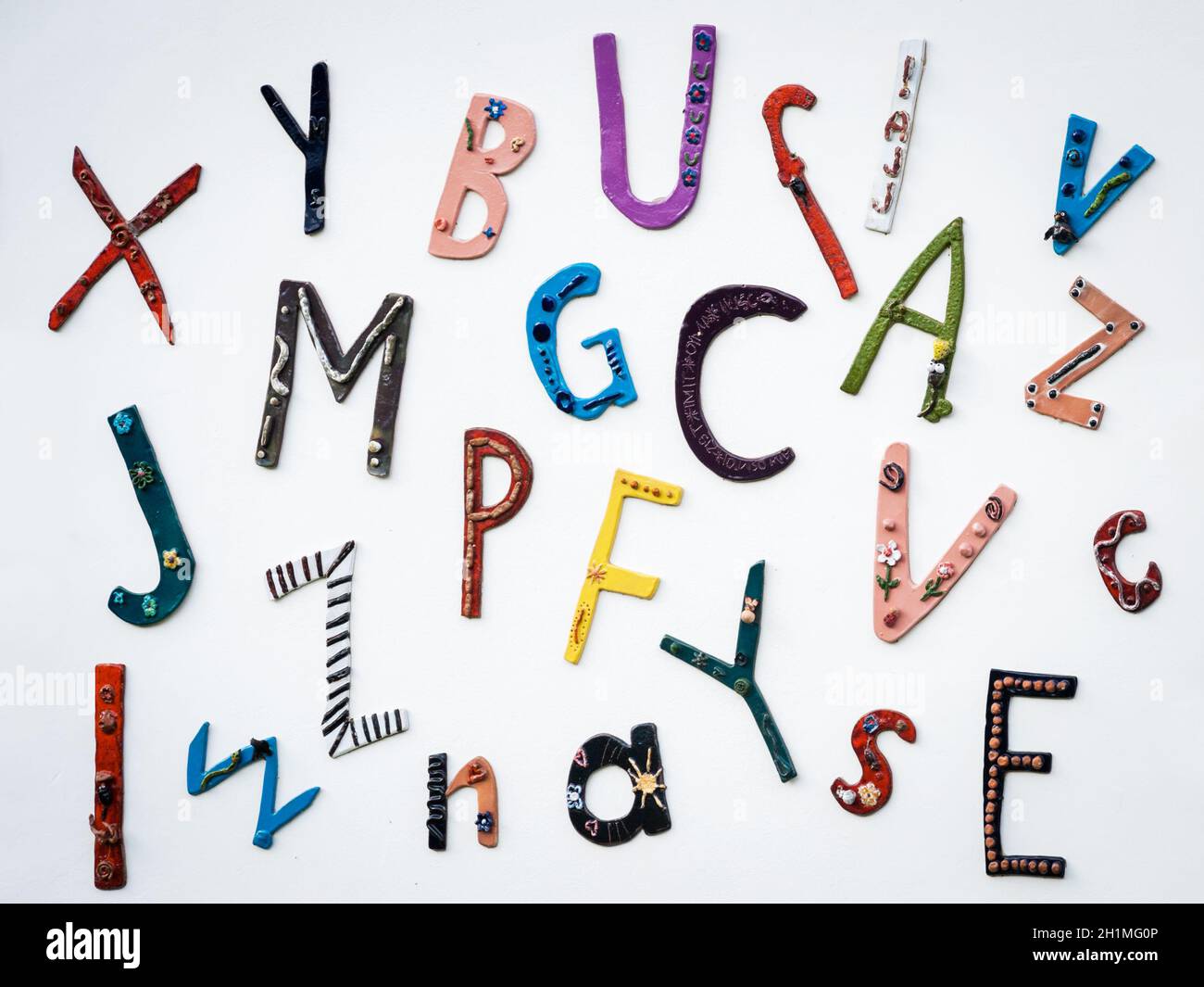 Letters of the alphabet on a white wall Stock Photo
