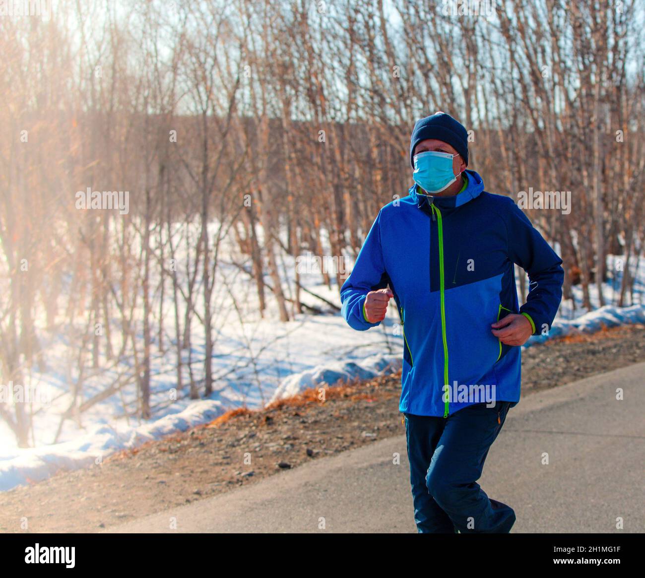 Runner wearing medical mask, Coronavirus pandemic Covid-19 in Europe. Sport, Active life Stock Photo