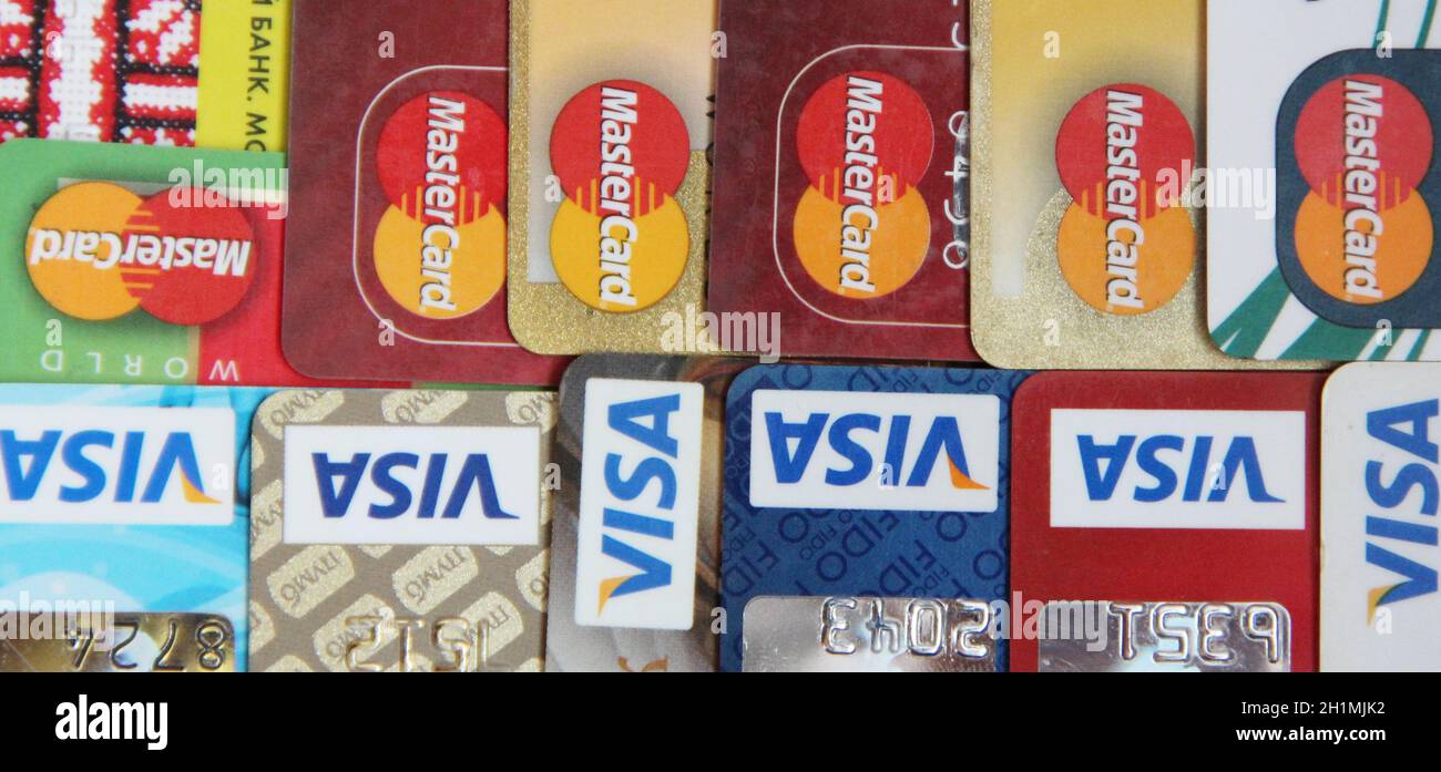 credit cards with VISA and MasterCard brand logos. Close up of many VISA and MASTER credit cards. Plastic bank cards of VISA and Mastercard. Internati Stock Photo