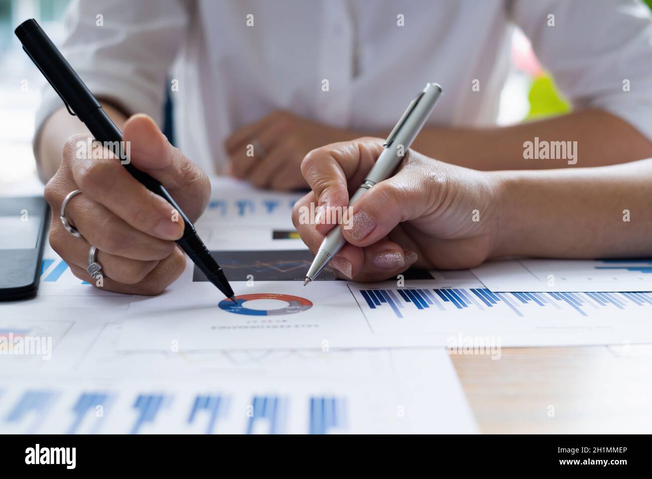 business people gather to discuss the company's market plan for the coming year. Teamwork Togetherness Unity Concept Stock Photo
