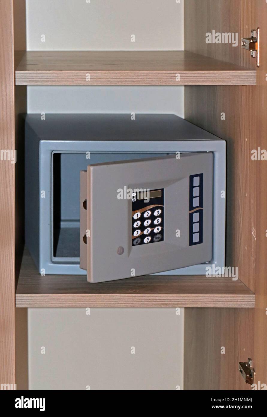 Modern digital pass code empty safe with open door on shelf in a hotel