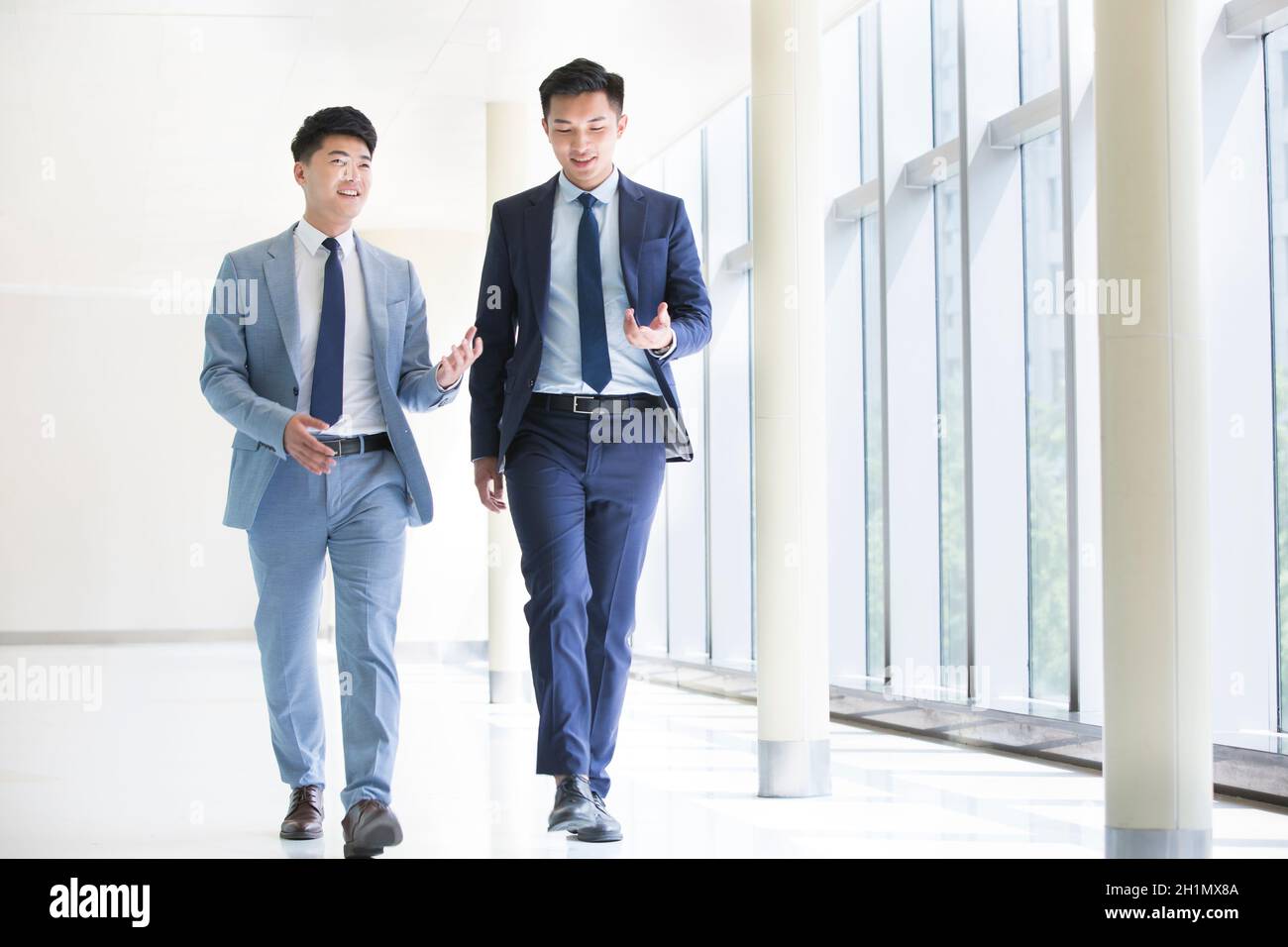 Two businessmen walking talking hi-res stock photography and images - Alamy