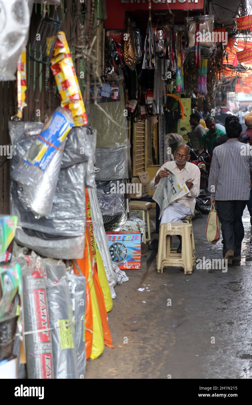 Indian man outside a shop selling car parts on Malick bazar in Kolkata
