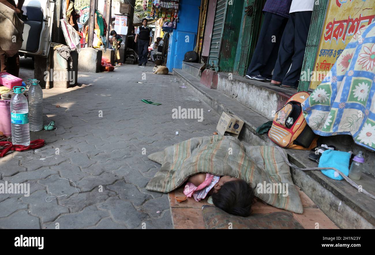 A little Indian girl sleeping on the street, Kolkata, India Stock Photo ...