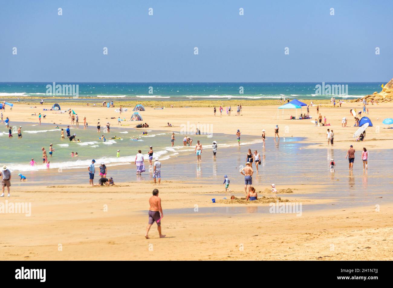 Vacationers and locals alike have a great time on the sandy Front Beach at Point Danger - Torquay, Victoria, Australia Stock Photo